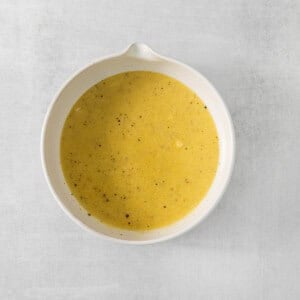 a white bowl filled with soup on top of a table.