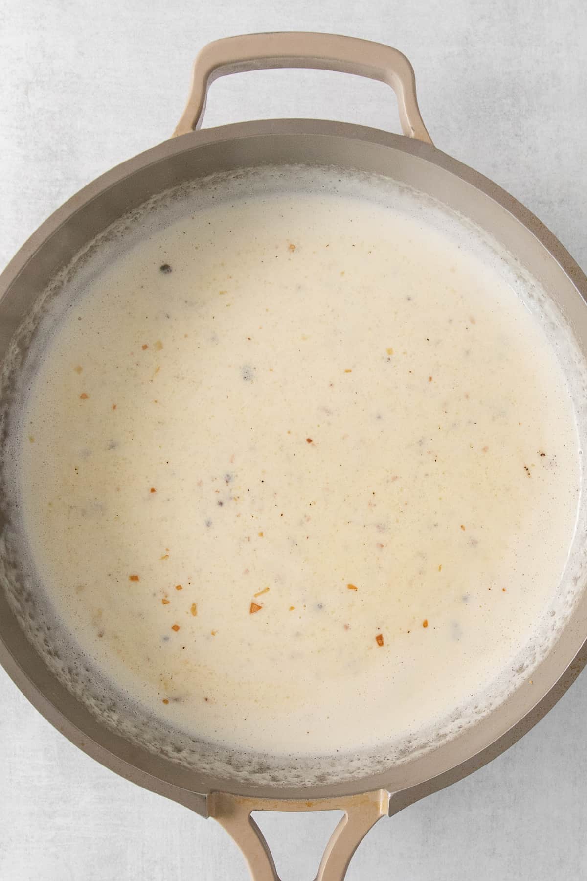 Alfredo sauce in a pan.