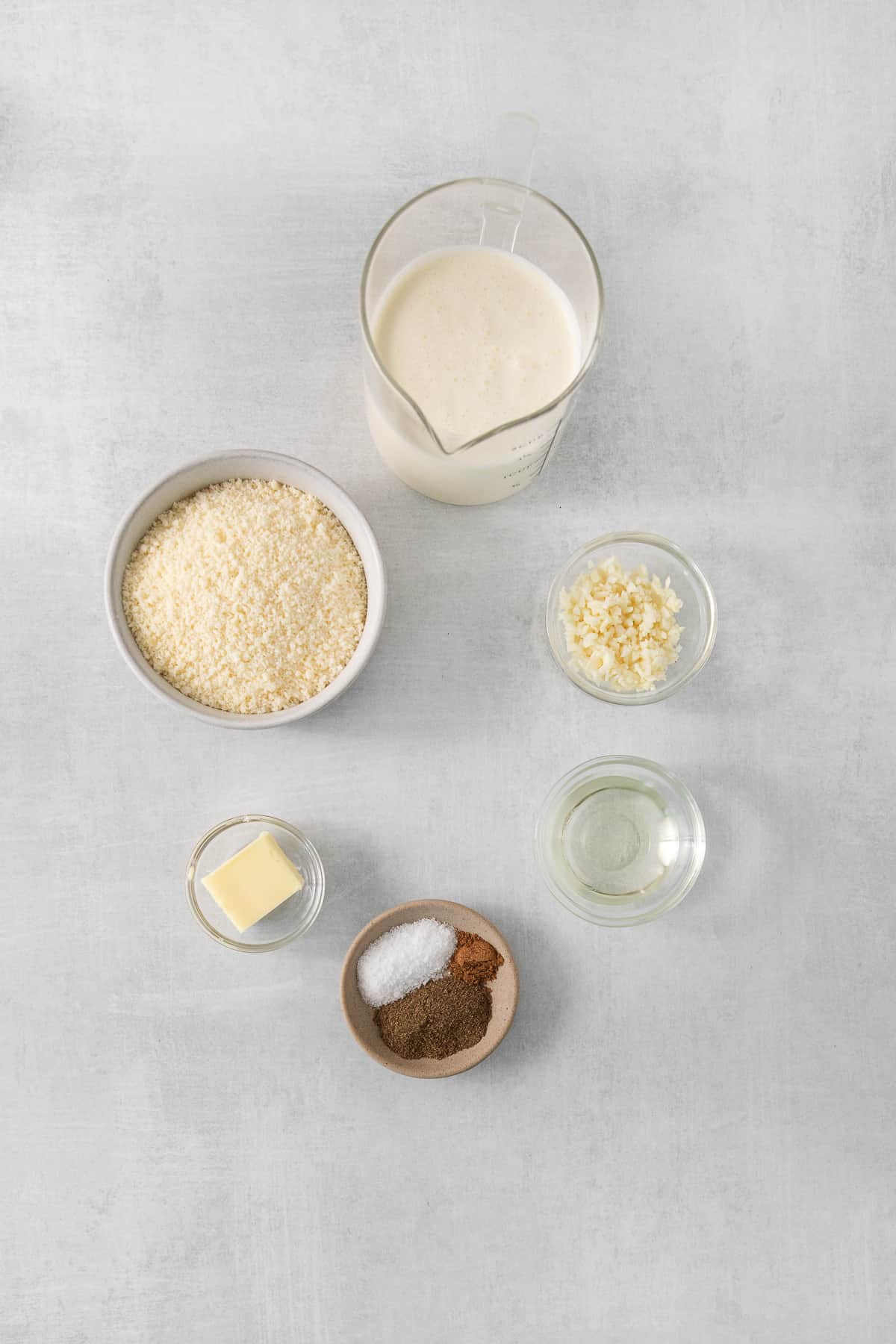 Ingredients for alfredo sauce in bowls.