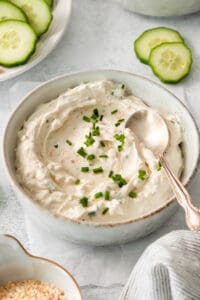 a bowl of cucumber dip with a spoon.