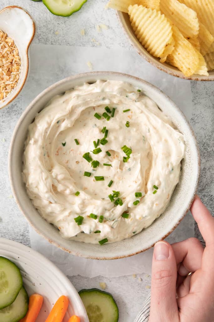 Chip dip in a bowl topped with fresh chives.