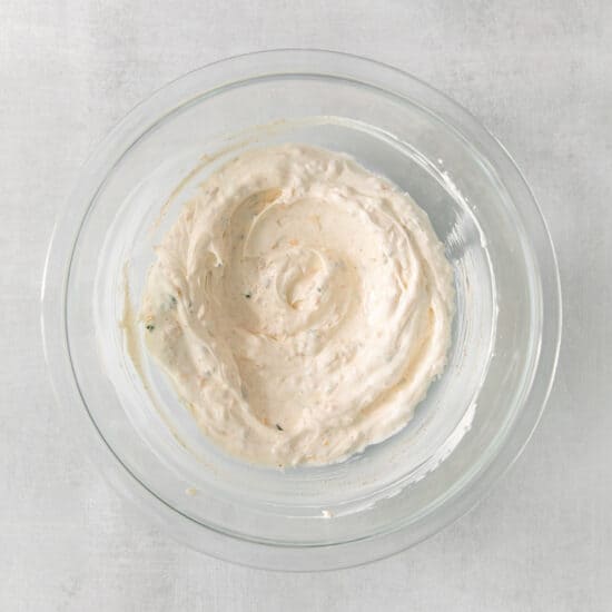 a bowl of hummus on a white background.