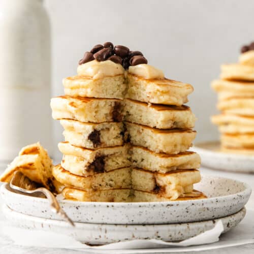 Cream cheese stuffed chocolate chip pancakes on a plate.