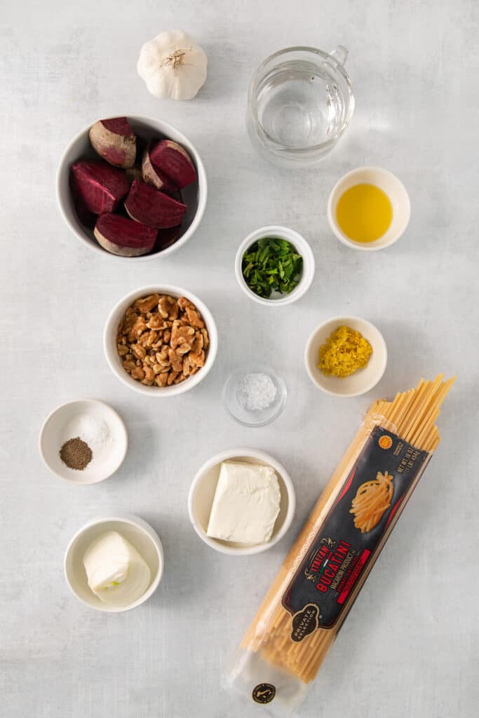 the ingredients for a pasta dish are laid out on a table.