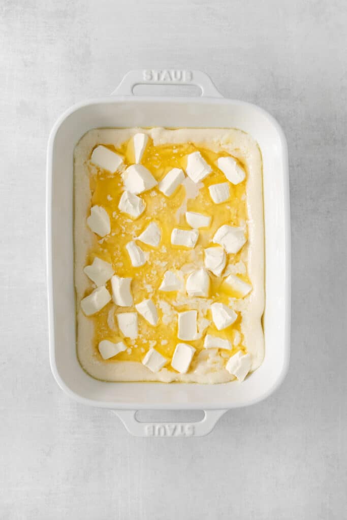 a casserole dish with cubed cheese in it.