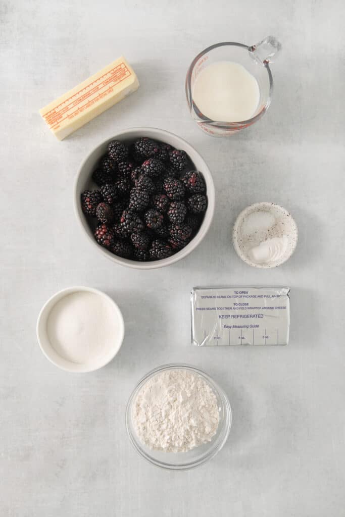 a bowl of berries, milk, and other ingredients to make a dessert.