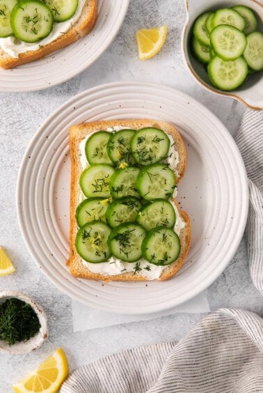 Cucumber and fresh dill on a piece of white bread.