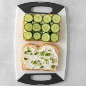 Cucumber, cream cheese, and fresh dill on white bread.