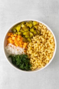 a bowl of macaroni and vegetables in a white bowl.