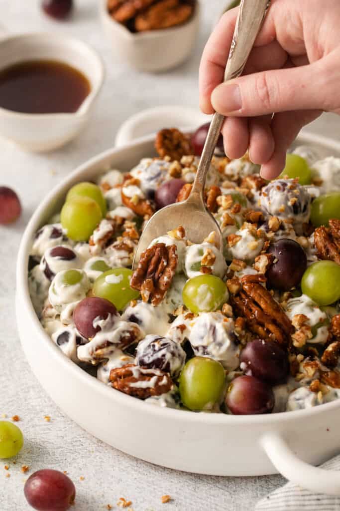 Grape salad with cream cheese on a spoon.