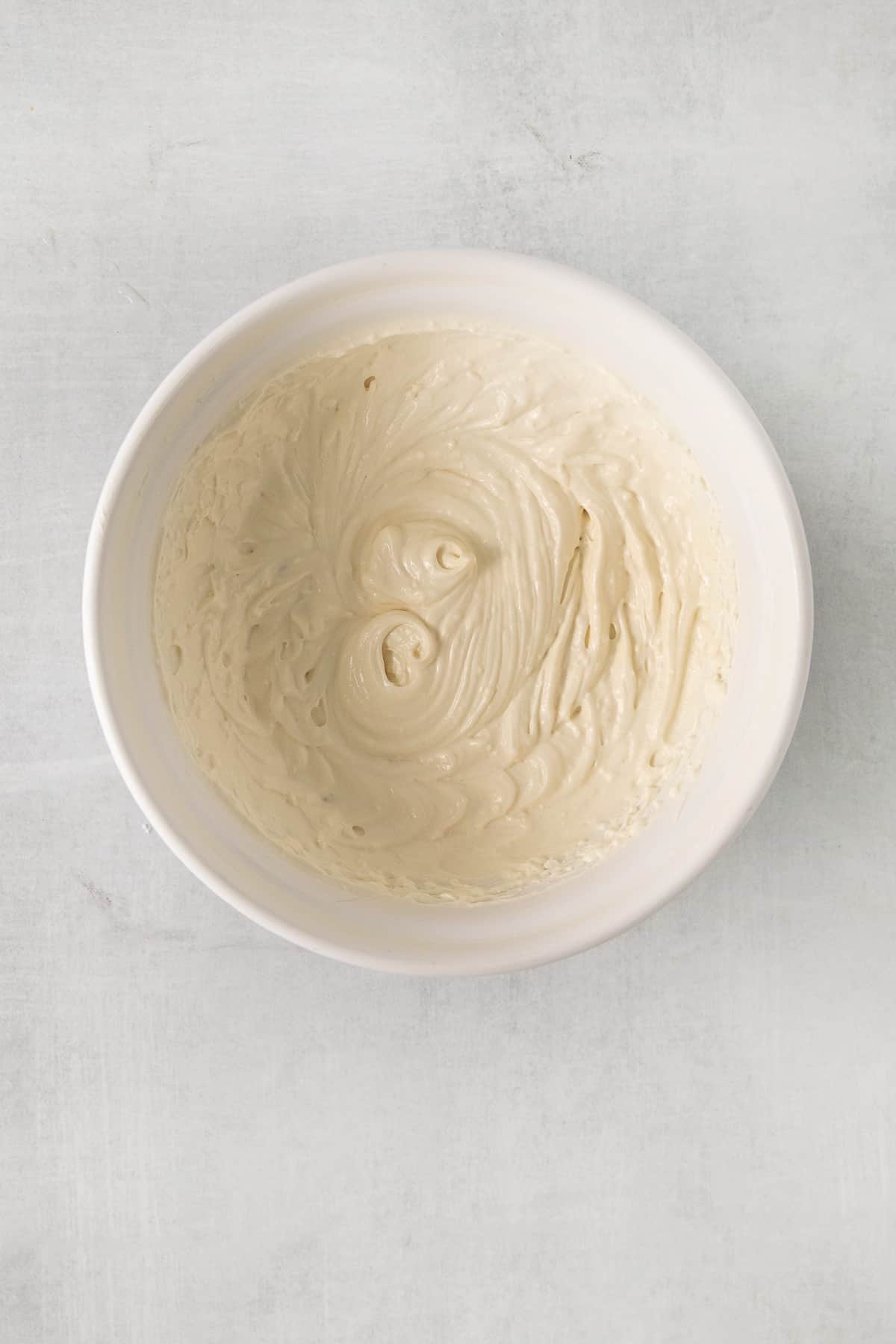 Cream cheese dressing for grape salad in a bowl.