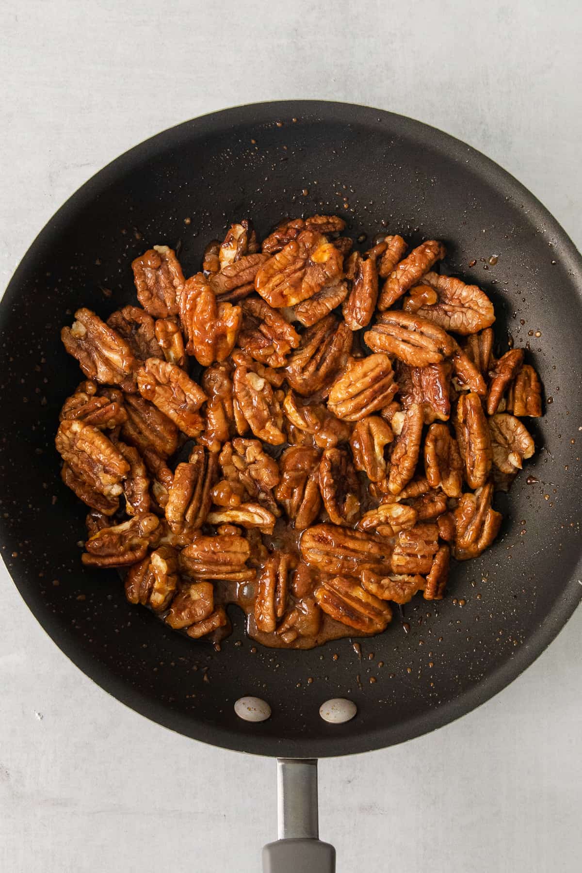 Toasted pecans in a skillet.