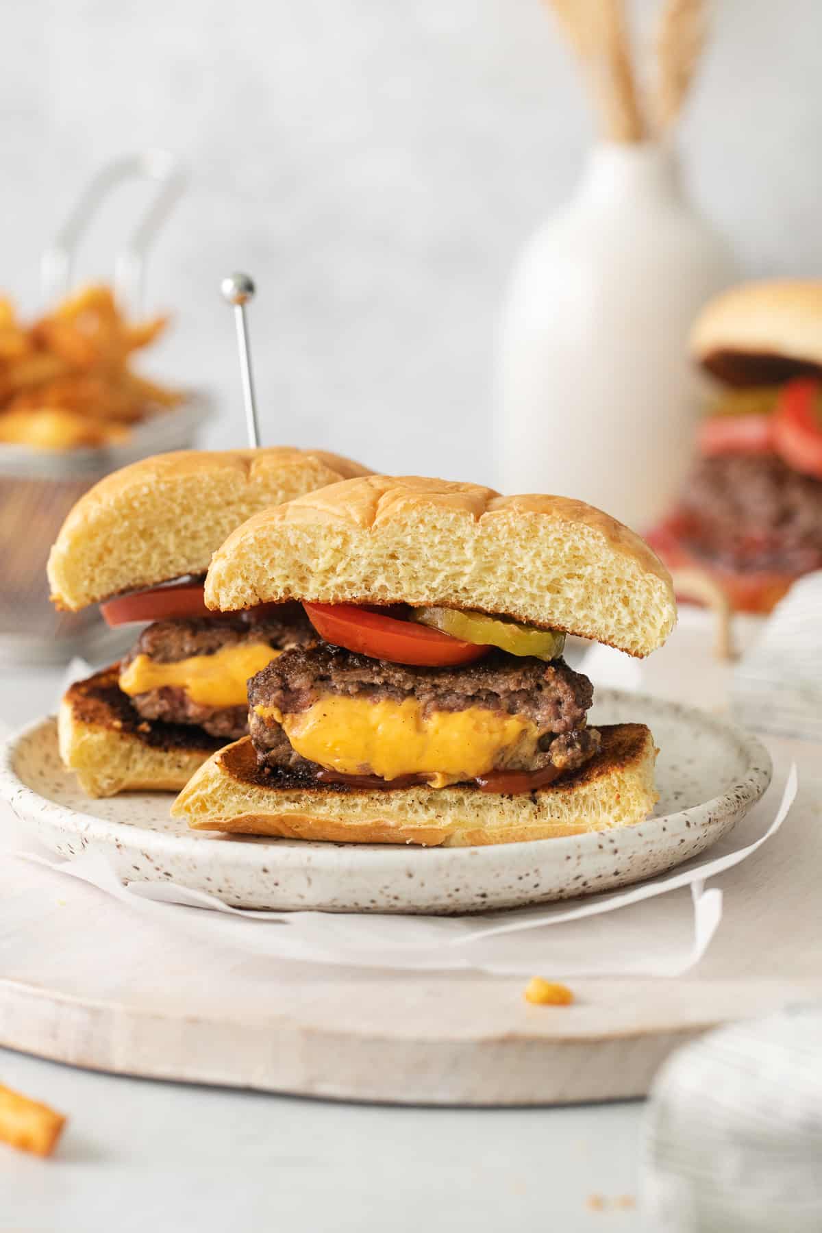 Jucy lucy burger cut in half on a plate.