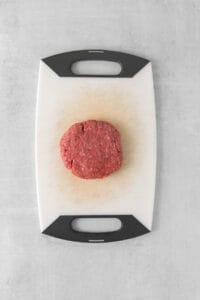 a piece of ground beef on a cutting board.