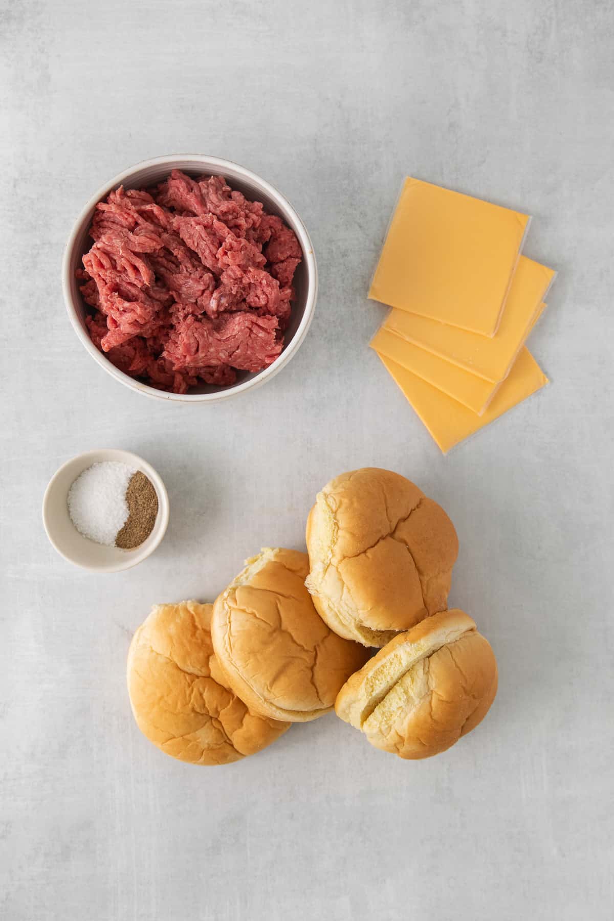 Ingredients for juicy lucy burgers on a counter.