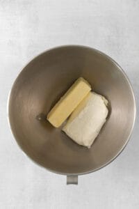 two pieces of butter in a metal bowl.