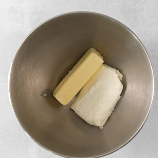 two pieces of butter in a metal bowl.