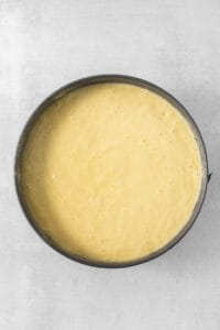 a yellow batter in a pan on a white surface.