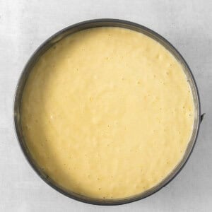 a yellow batter in a pan on a white surface.