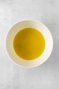 olive oil in a white bowl on a white background.