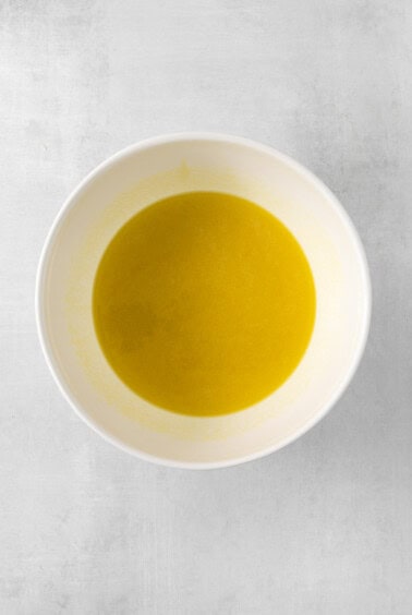 olive oil in a white bowl on a white background.