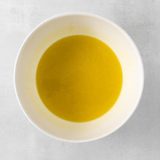 olive oil in a white bowl on a white background.