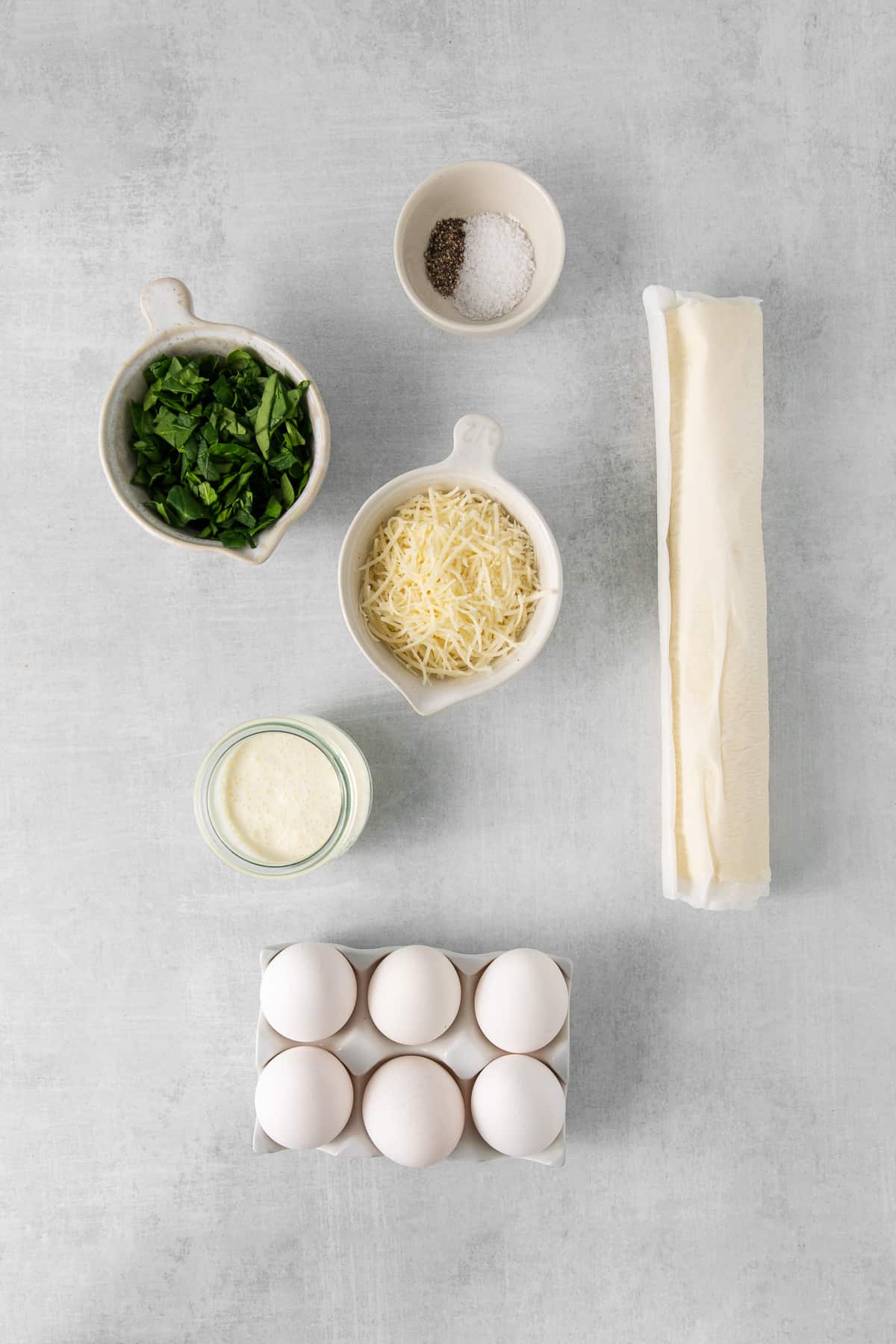 Ingredients for quiche florentine in bowls.