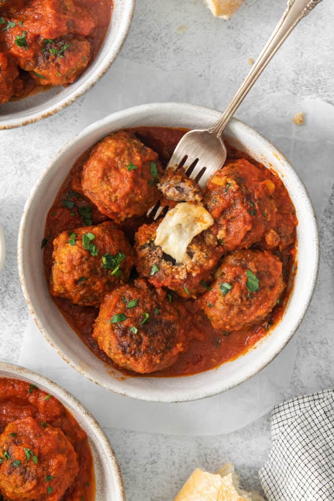 meatballs in tomato sauce with a fork.