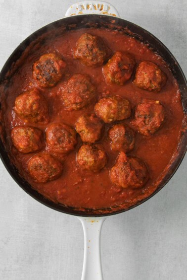 meatballs in tomato sauce in a skillet.