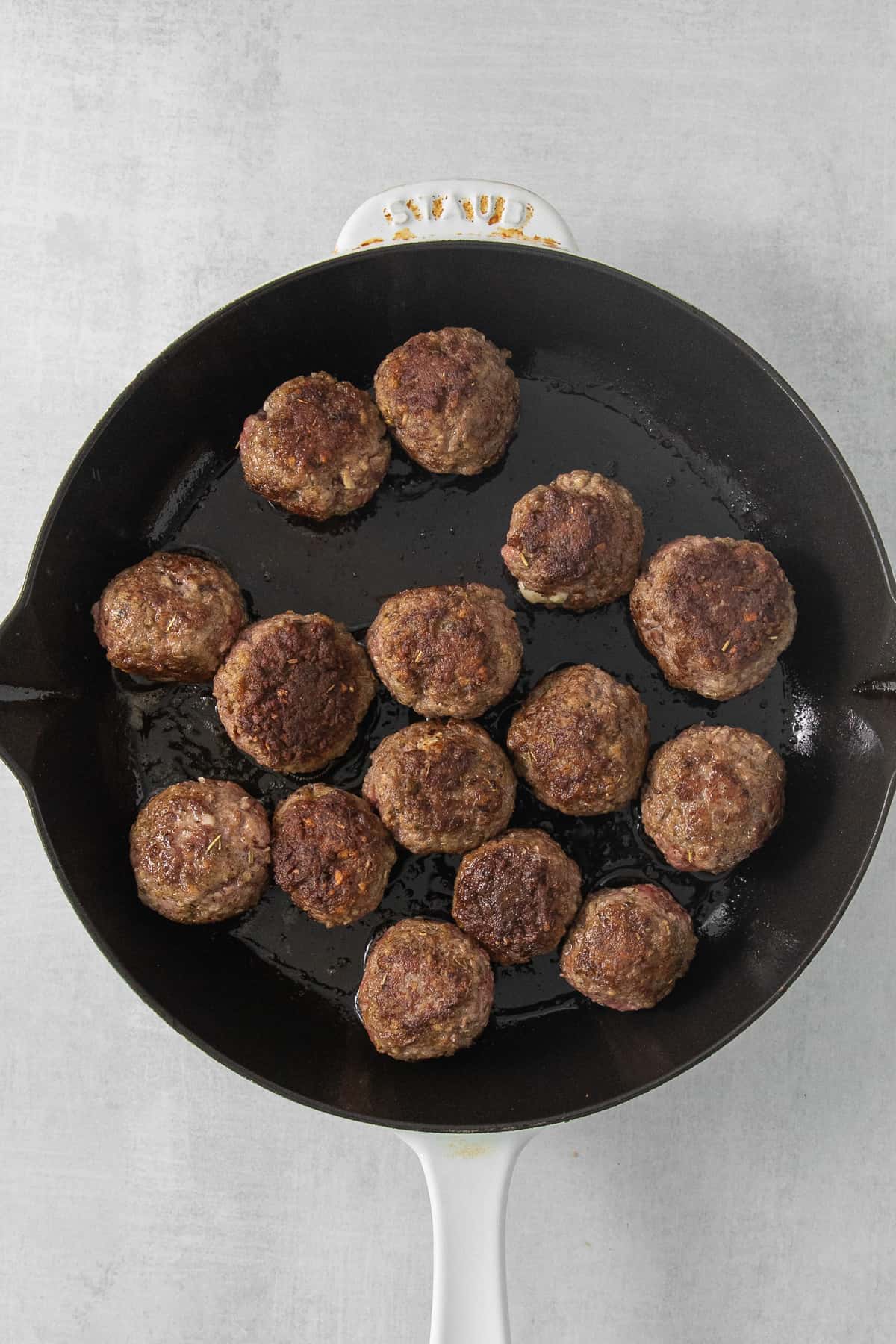 meatballs in a skillet on a white background.