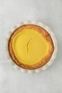 a pie with lemon filling in a white dish.