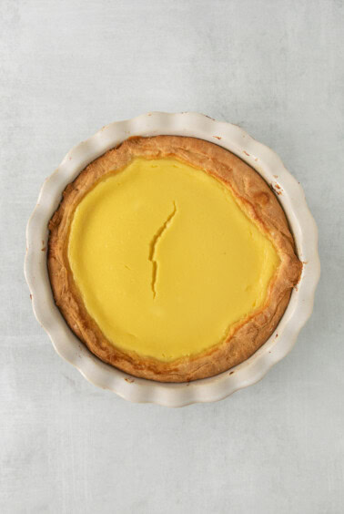 a pie with lemon filling in a white dish.