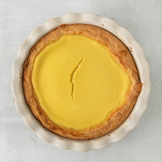 a pie with lemon filling in a white dish.