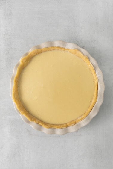 a pie with a yellow filling on a white surface.