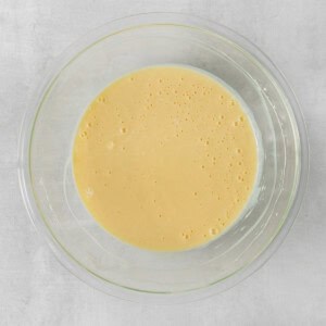 a glass bowl with a yellow liquid in it.