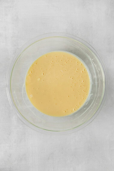 a glass bowl with a yellow liquid in it.