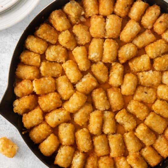 a skillet filled with tater tots.
