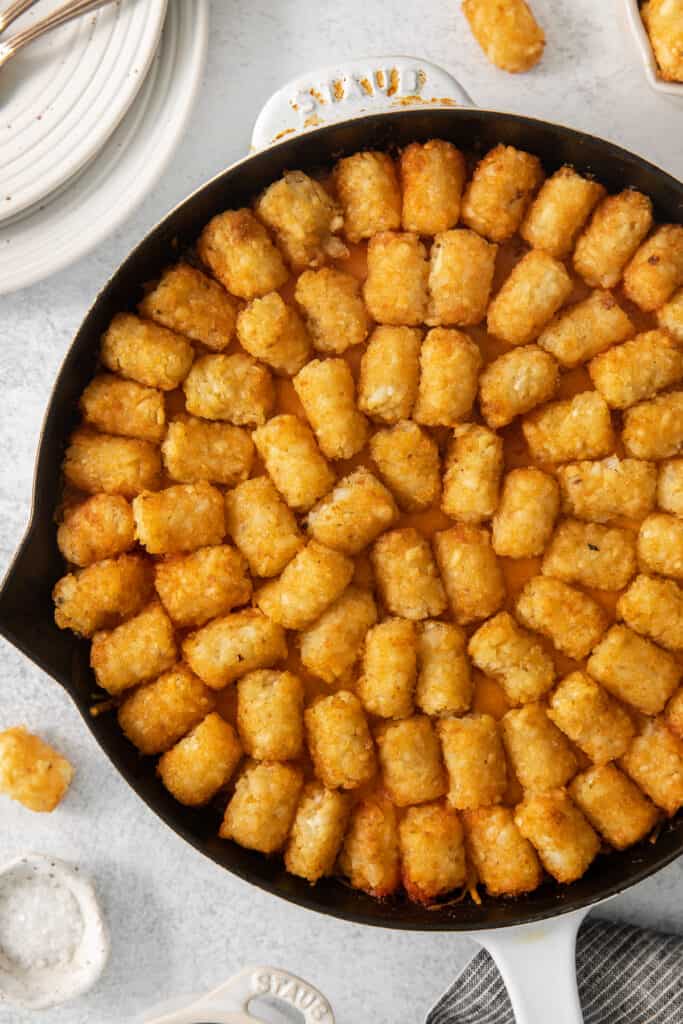 a skillet filled with tater tots.