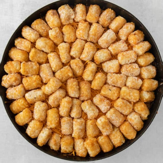 cheesy tater tots in a skillet.