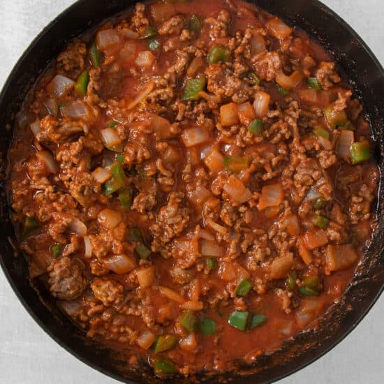 a skillet filled with meat and vegetables.