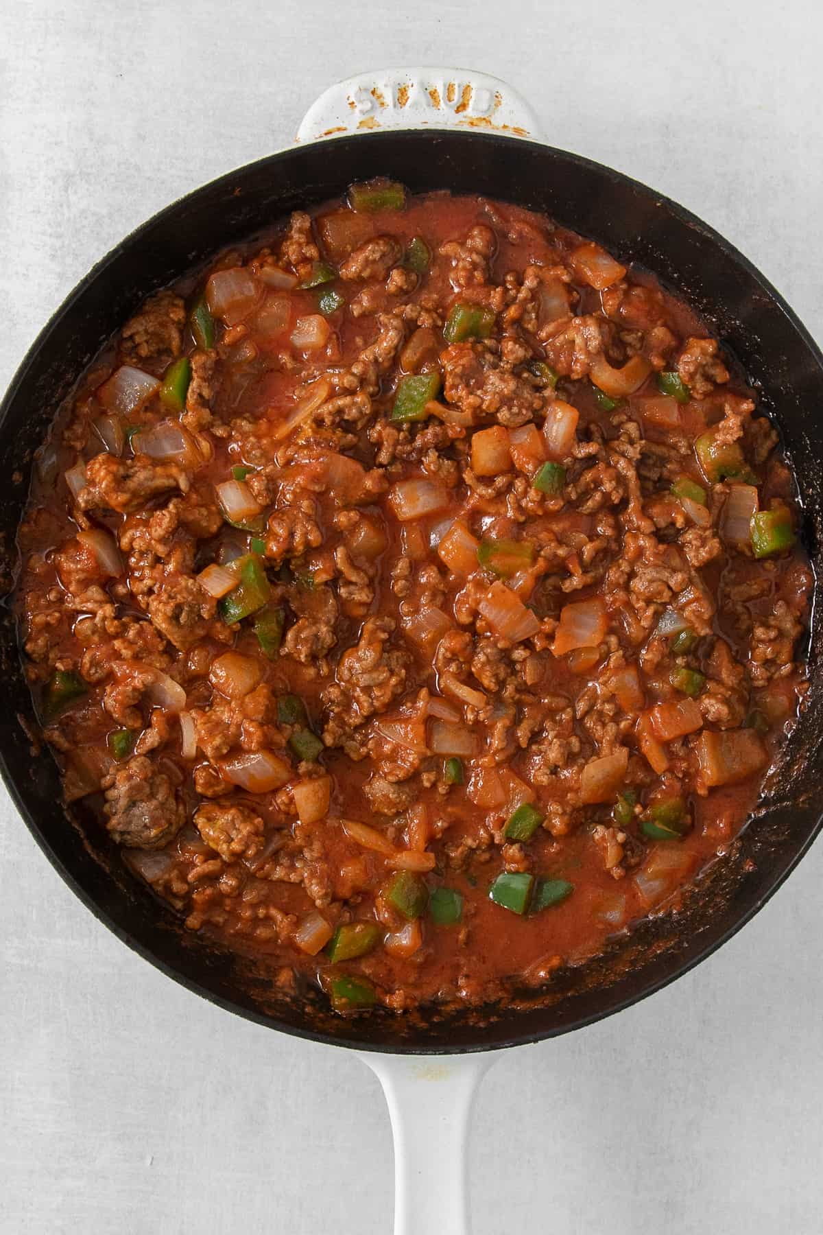 a skillet filled with meat and vegetables.