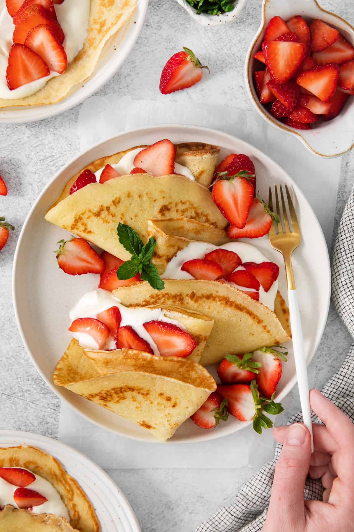 Strawberry crepes on a plate.