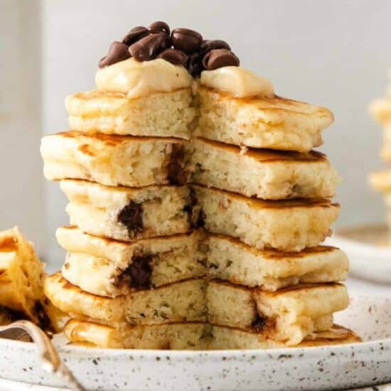 Cream cheese stuffed chocolate chip pancakes on a plate.