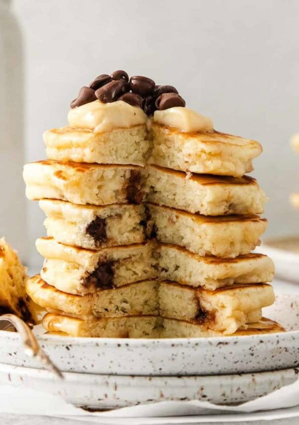 Cream cheese stuffed chocolate chip pancakes on a plate.