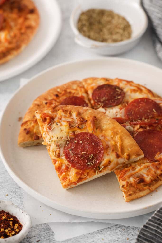 Air fryer frozen pizza slices on a plate.