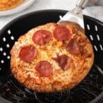 Frozen pizza coming out of the air fryer.