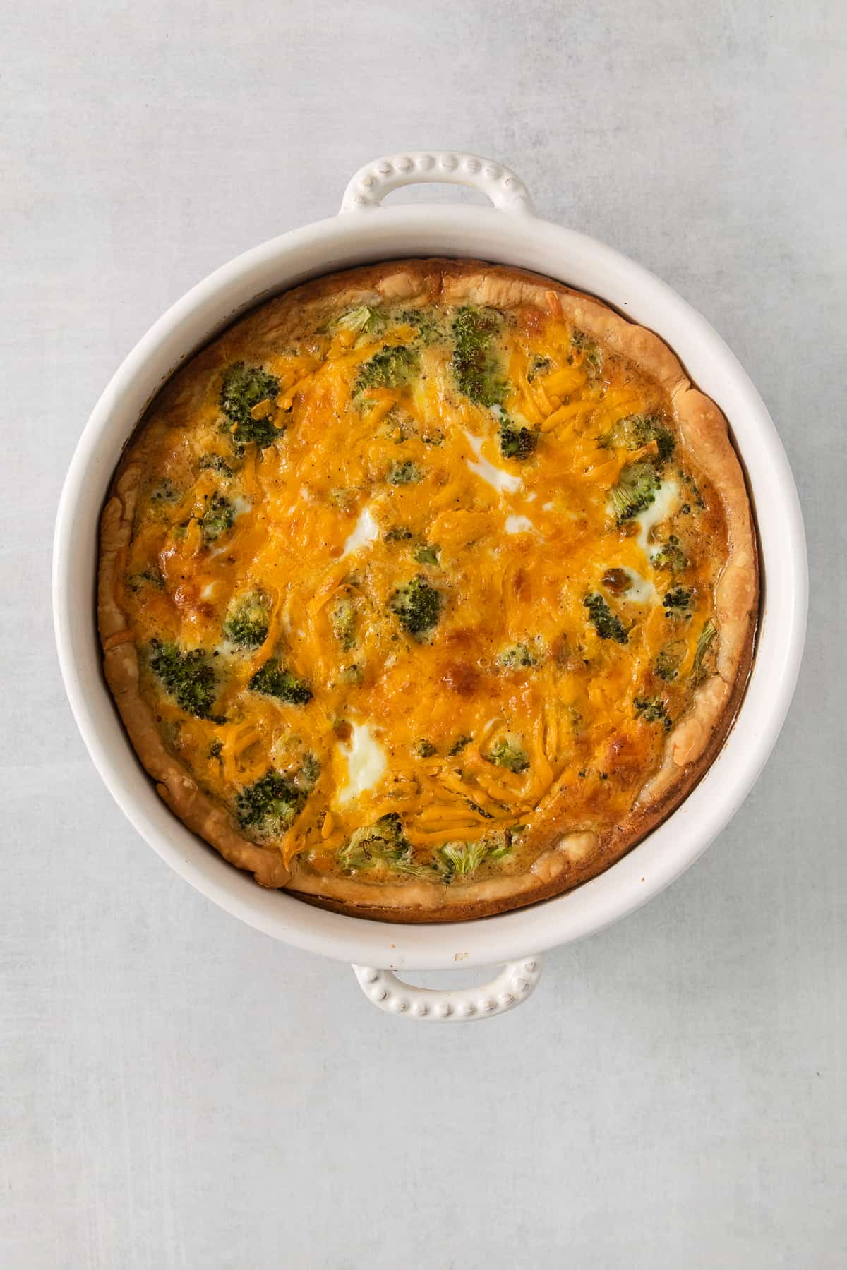 a casserole dish with broccoli and cheese.