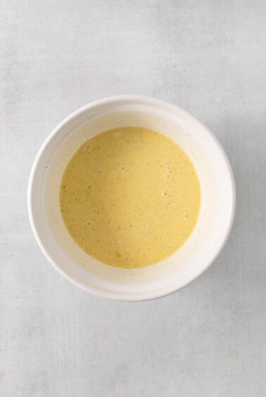 a white bowl filled with soup on top of a table.