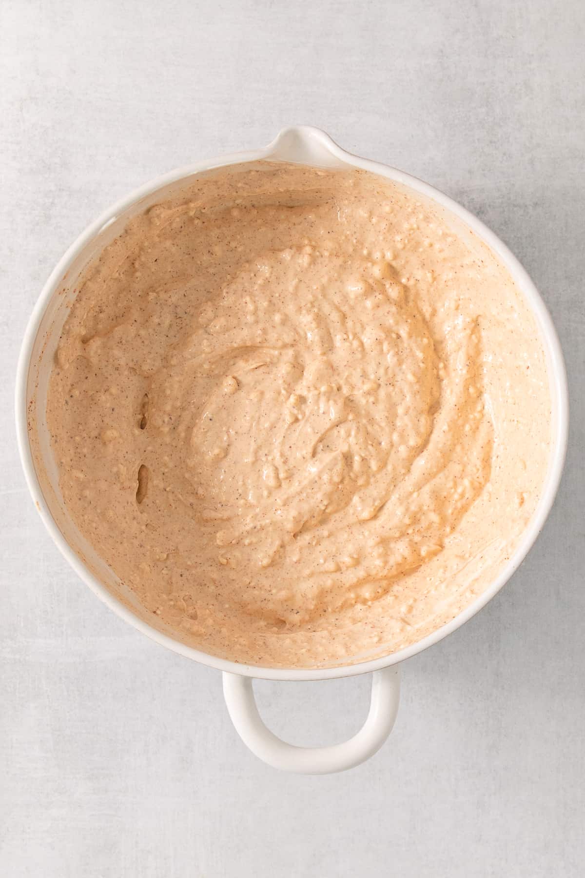 a bowl of hummus sitting on top of a table.