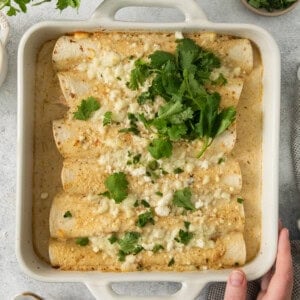 enchiladas in a white baking dish.